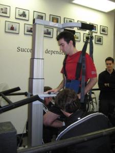 Simulating a walking motion while being suspended in a harness over a treadmill